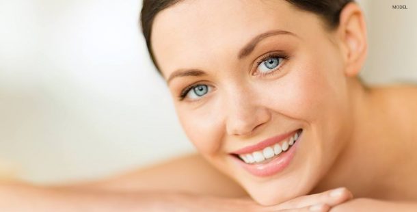 Close Up of Female Face with Light Gray Eyes Smiling