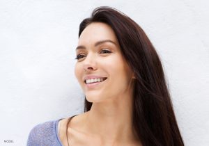 Headshot of Woman with Dark Brown Hair & a Sculpted Nose Looking to the Side